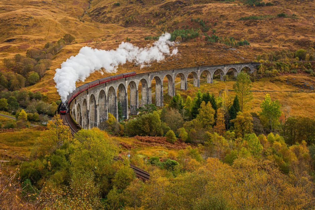 Old Fashioned Steam Train with Air Whistle on Glenfinnan Viaduct, Scotland in Autumn