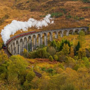 Old Fashioned Steam Train with Air Whistle on Glenfinnan Viaduct, Scotland in Autumn