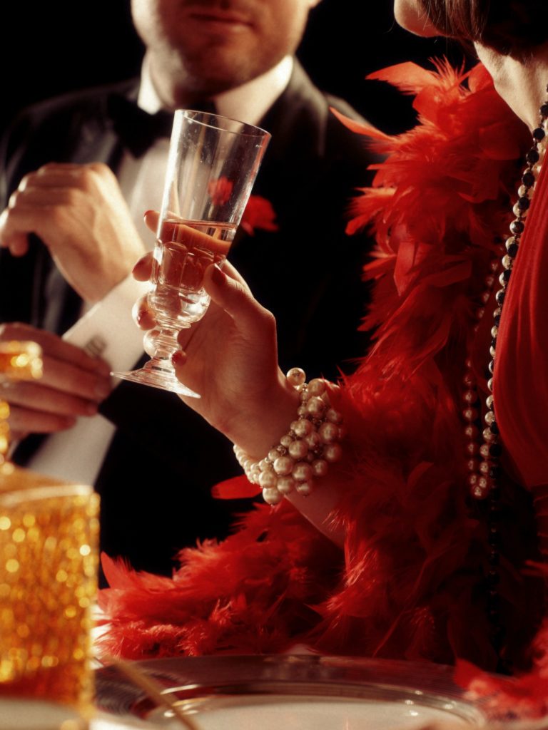 People in 1920s style dinner scene