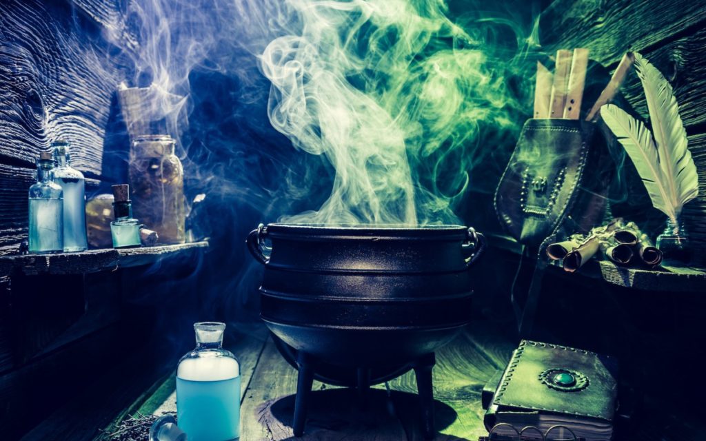 Vintage witcher cauldron with books and magic potions for Halloween